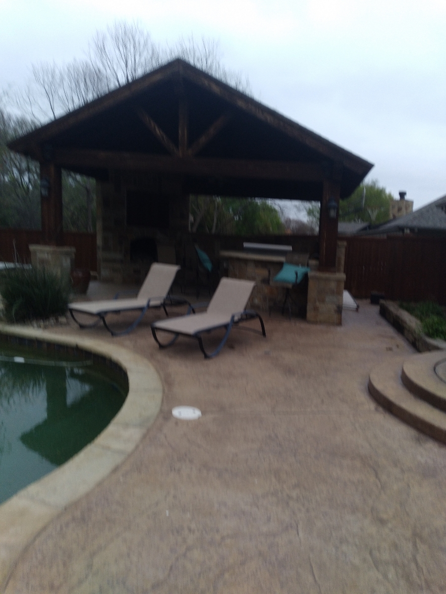 Stained pergola with cleaned ground surface